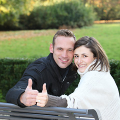 Image showing Happy young couple giving a thumbs up