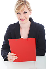 Image showing Cheerful businesswoman with a red clipboard