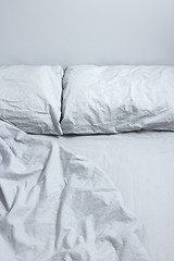 Image showing Messy bed with gray bedclothes