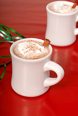 Image showing Two cups of hot chocolate with green ribbon