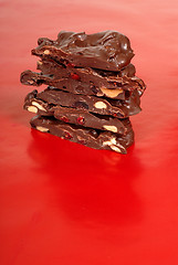 Image showing Chocolate cashew and dried cherry bark on a red background