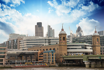 Image showing City of London with clouds, financial center and Canary Wharf at