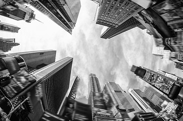 Image showing Upward fisheye view of tall skyscrapers against a blue sky in th