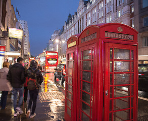 Image showing Red Telephone Booth in London on a crowded street at night