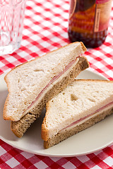 Image showing ham sandwich on checkered tablecloth