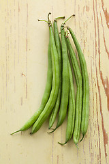 Image showing bean pods on wooden table