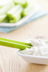 Image showing green celery sticks with tasty dip