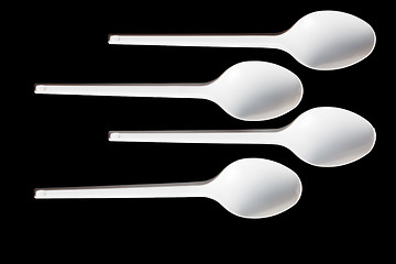 Image showing plastic spoons on black background