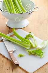 Image showing green celery sticks on kitchen table