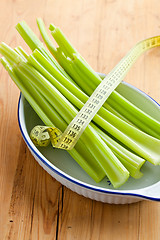 Image showing green celery sticks on kitchen table