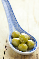 Image showing the green olives in ceramic spoon