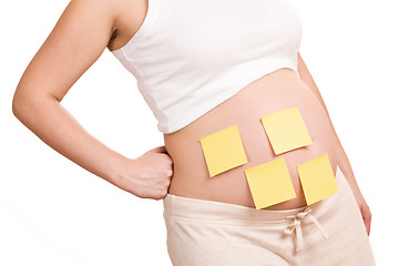 Image showing pregnant women with notepaper on her belly