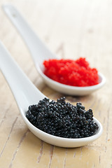 Image showing red and black caviar in ceramic spoon