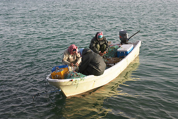 Image showing Three men in a boat