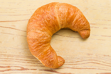 Image showing fresh croissant on wooden table