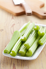 Image showing green celery sticks on kitchen table