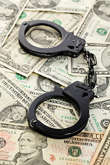 Image showing handcuffs on dollars