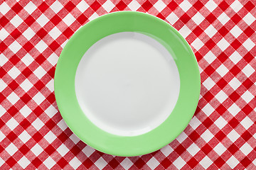 Image showing green plate on checkered tablecloth