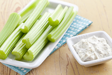 Image showing green celery sticks with tasty dip