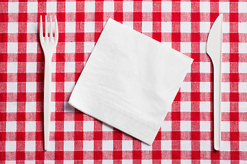 Image showing plastic cutlery on checkered tablecloth