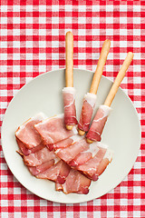 Image showing grissini sticks with ham