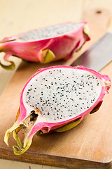 Image showing pink pitahaya on wooden table