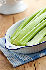 Image showing green celery sticks on kitchen table