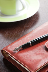 Image showing pen on diary and coffee mug