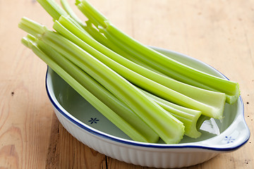 Image showing green celery sticks on kitchen table