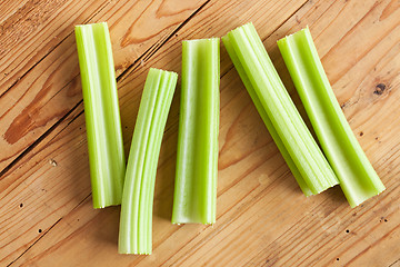 Image showing green celery sticks on kitchen table