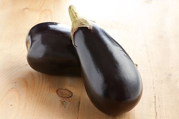 Image showing two eggplants on wooden table