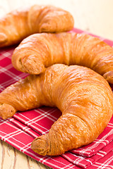 Image showing fresh croissants on checkered napkin