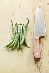 Image showing bean pods with knife