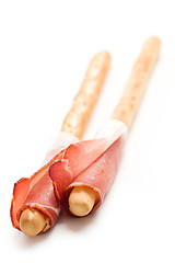 Image showing grissini sticks with ham