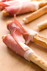 Image showing grissini sticks with ham