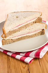 Image showing ham sandwich on checkered napkin