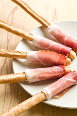 Image showing grissini sticks with ham