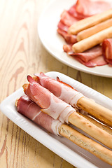Image showing grissini sticks with ham