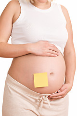 Image showing pregnant women with notepaper on her belly