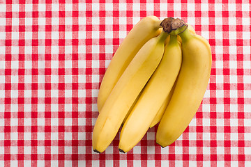 Image showing yellow bananas on checkered tablecloth