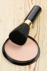 Image showing makeup brush and cosmetic powder compact 