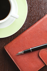 Image showing pen on diary and coffee mug