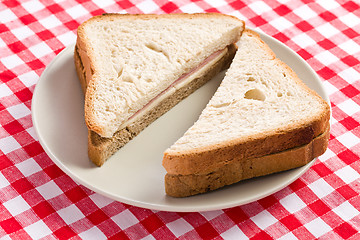 Image showing ham sandwich on checkered tablecloth