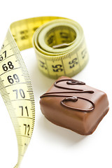 Image showing chocolate praline with measuring tape