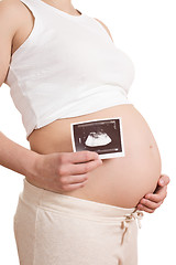 Image showing pregnant woman is holding a photo of her Ultrasound