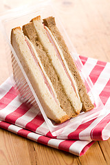 Image showing ham sandwich on checkered napkin