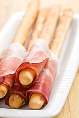 Image showing grissini sticks with ham