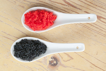 Image showing red and black caviar in ceramic spoon