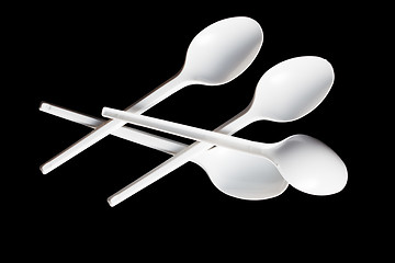 Image showing plastic spoons on black background