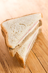 Image showing ham sandwich on wooden table 